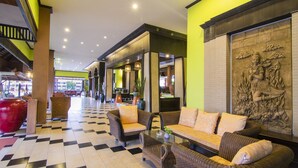 A lobby with checkered flooring, wicker furniture, and a large decorative wall. - Phuphaya Resort Pattaya (Pattaya)