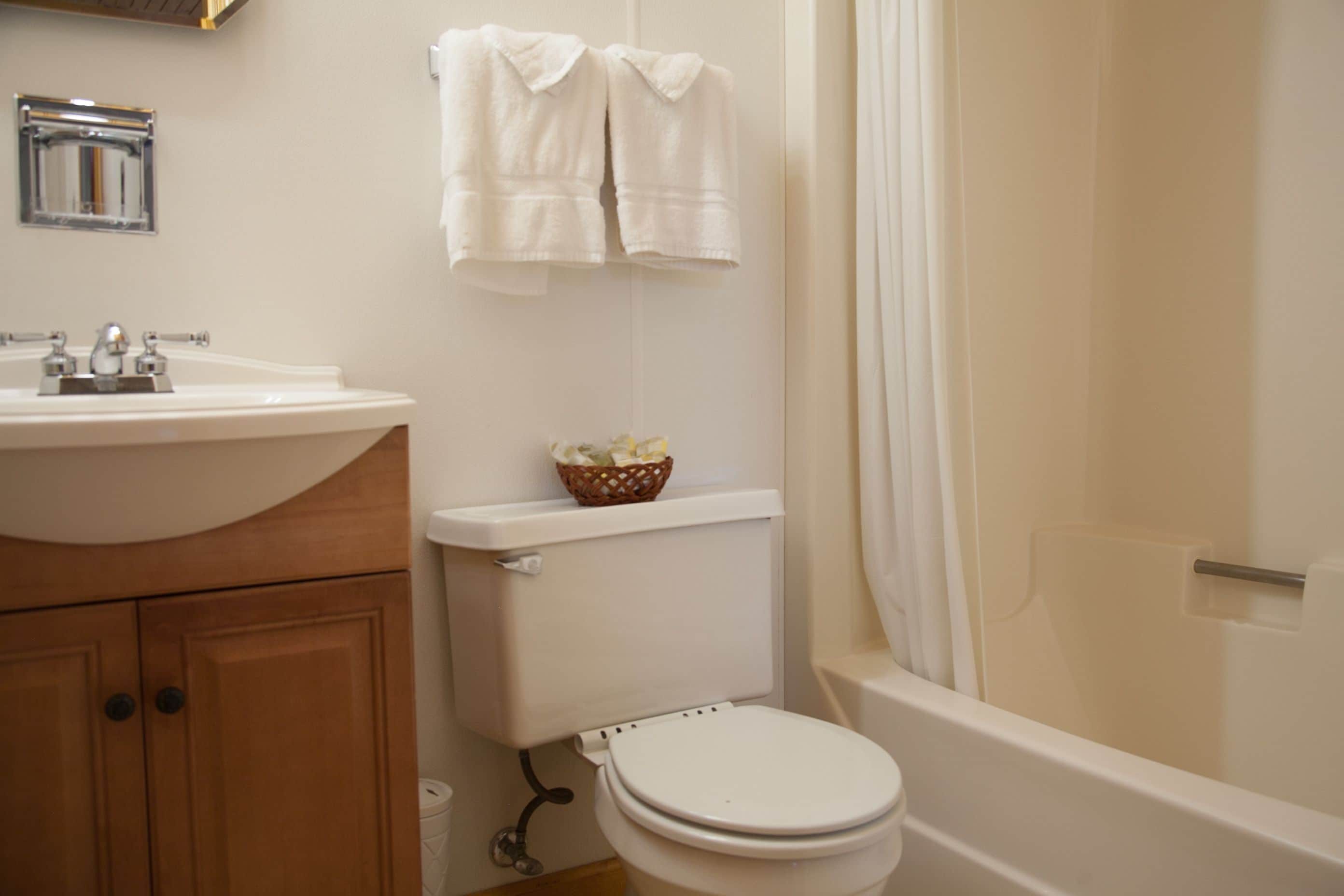 A bathroom with a sink, toilet, and bathtub.