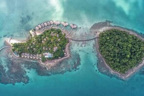 An aerial view of a tropical island with a resort area featuring villas and a beach. - SONG SAA PRIVATE ISLAND (Koh Ouen)