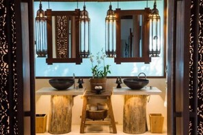 A kitchen with two sinks, a wooden stool, and hanging lanterns. - SONG SAA PRIVATE ISLAND (Koh Ouen)