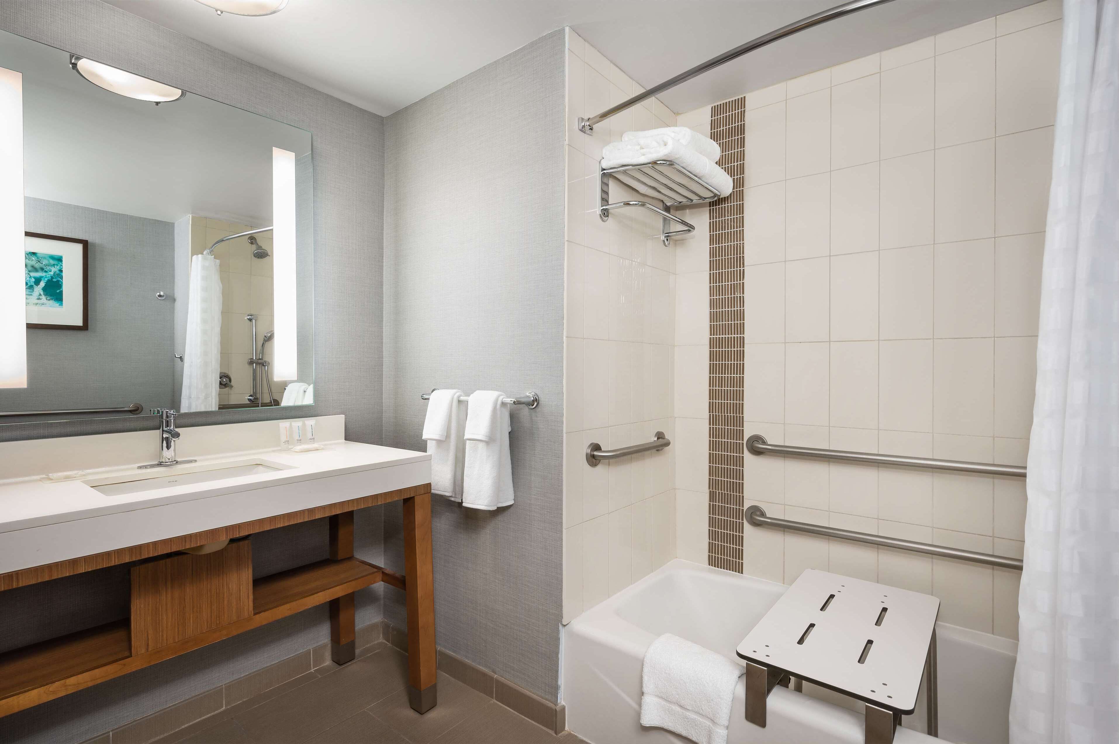 combined shower/bathtub, designer toiletries, hair dryer, towels