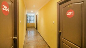 A hotel corridor with doors numbered 204 and 203, leading to rooms. - Hotel Udupi Park Inn (Bengaluru)