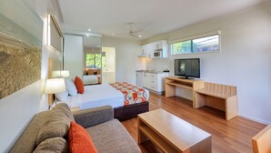 A compact room with a bed, a sofa, a desk, a television, and a kitchenette. - Chinchilla Motor Inn (Chinchilla)