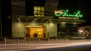 A hotel entrance with a neon sign reading "HOTEL Senil De Maison De La Salle" and a staircase leading to the lobby. - Hotel Benilde Maison De La Salle (Manila)