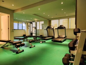 Stay fit on the go with our fully equipped gym featuring treadmills, a weight bench, and free weights.