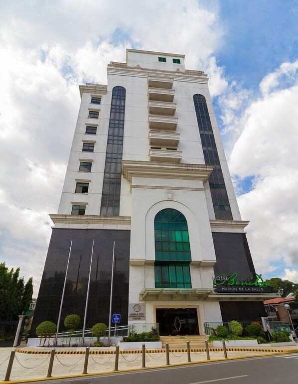 Hotel Benita offers a striking central entrance with a large arched doorway and symmetrical design.