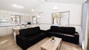 Bushland Villa | Living area | 43-inch flat-screen TV with digital channels, TV - Koala Shores Port Stephens Holiday Park (Lemon Tree Passage)