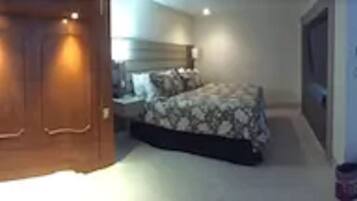 Relax in a stylish room with a large wardrobe, comfortable bed, and cozy seating area.
