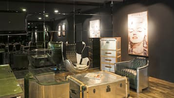 Relax in a cozy space with a leather armchair, cushioned chair, and sofa, perfect for unwinding and entertainment.