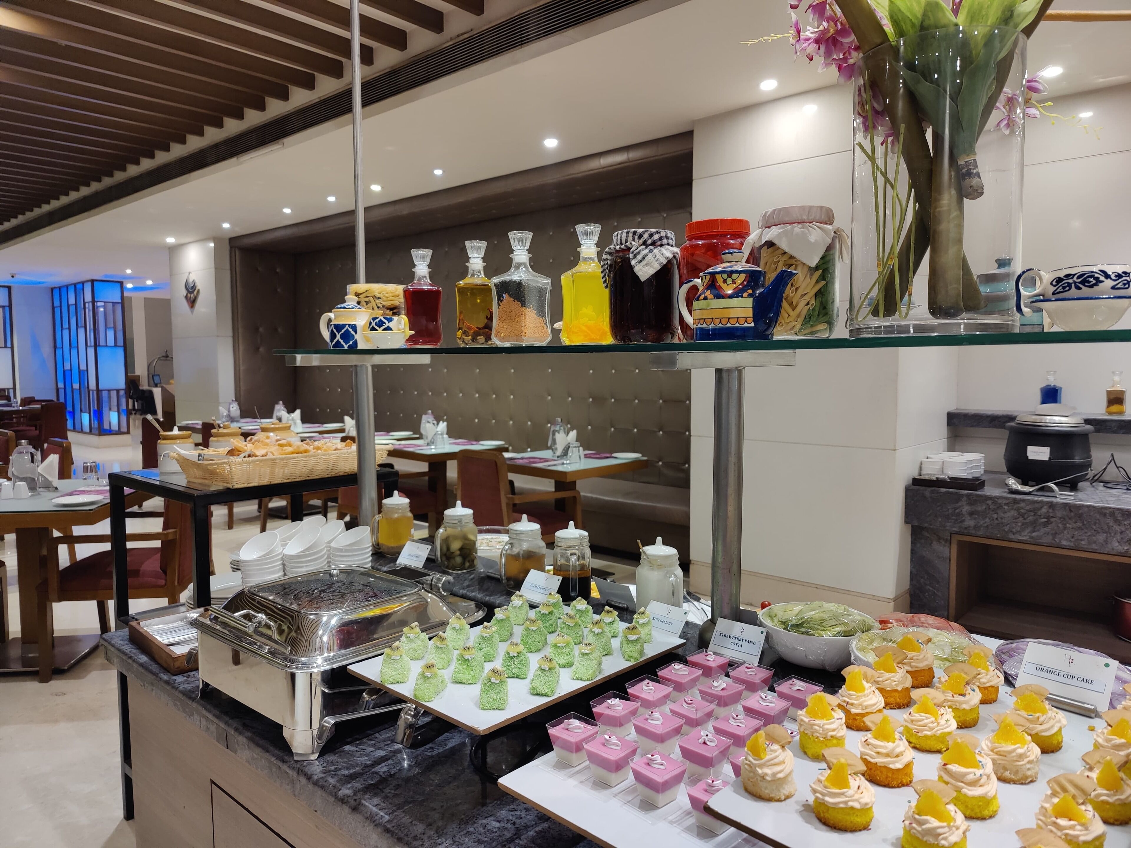 A buffet area with various food items and condiments.