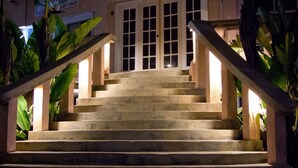 A staircase leading to a building entrance at night, with steps illuminated by lights.