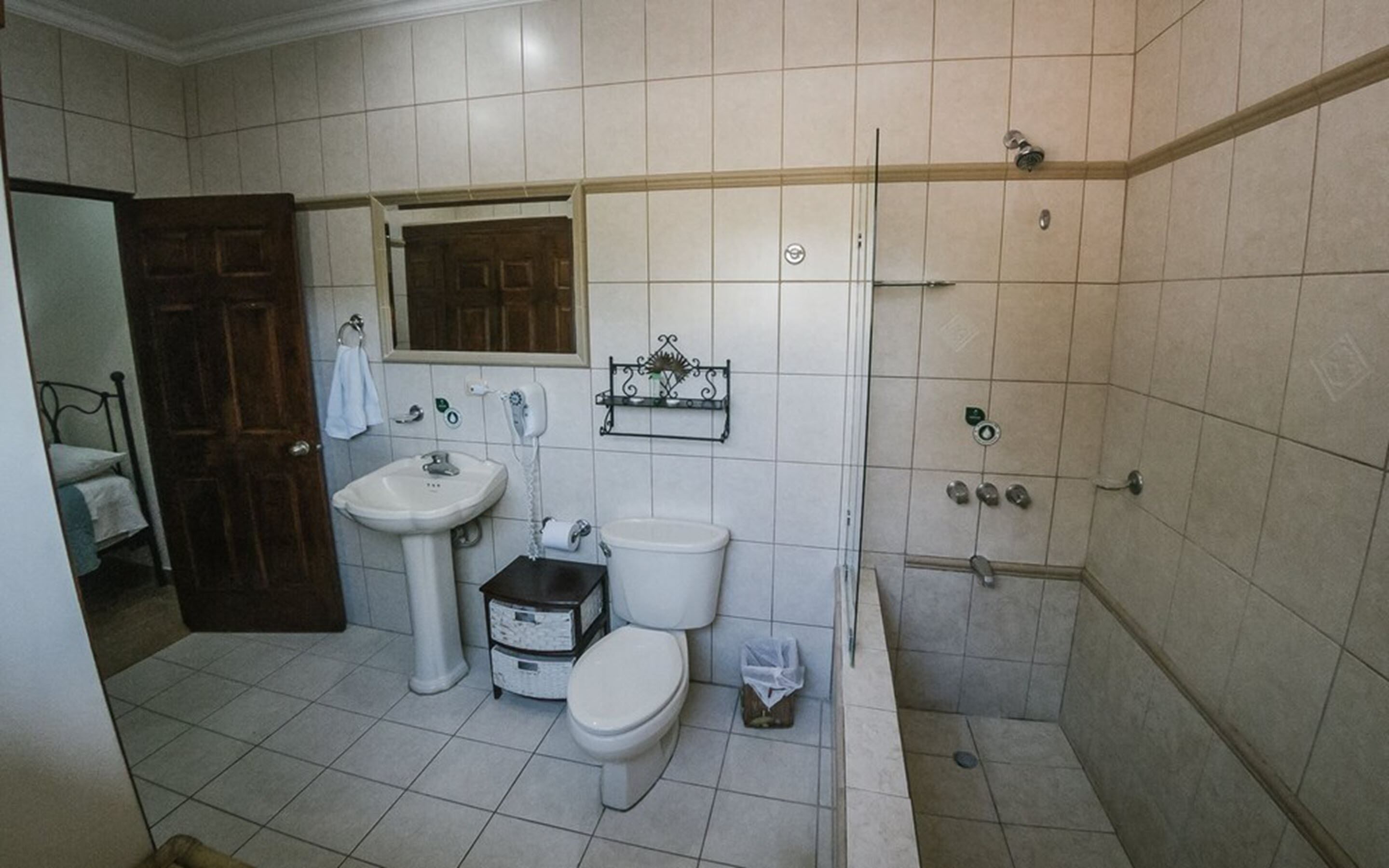 A bathroom with a sink, toilet, and shower.