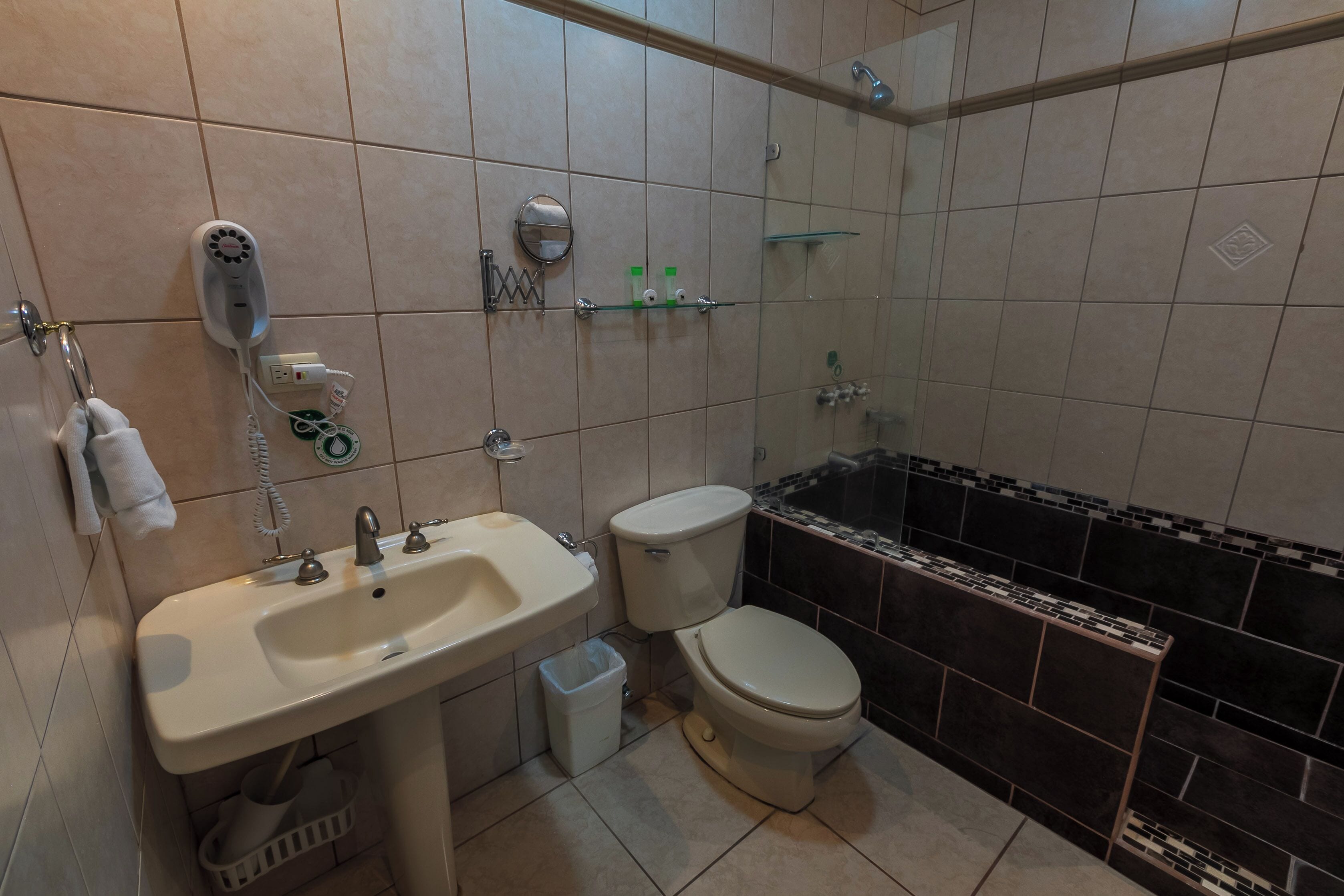 A bathroom with a sink, toilet, and bathtub.