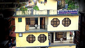 A multi-story building with a sign for Pilgrims-Guest House Pvt. Ltd. and Pilgrims Garden Restaurant. - Pilgrims Guest House (Kathmandu)
