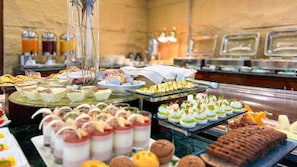 A buffet with various food items including desserts, pastries, and fruits. - City Tower Hotel (Kuwait City)