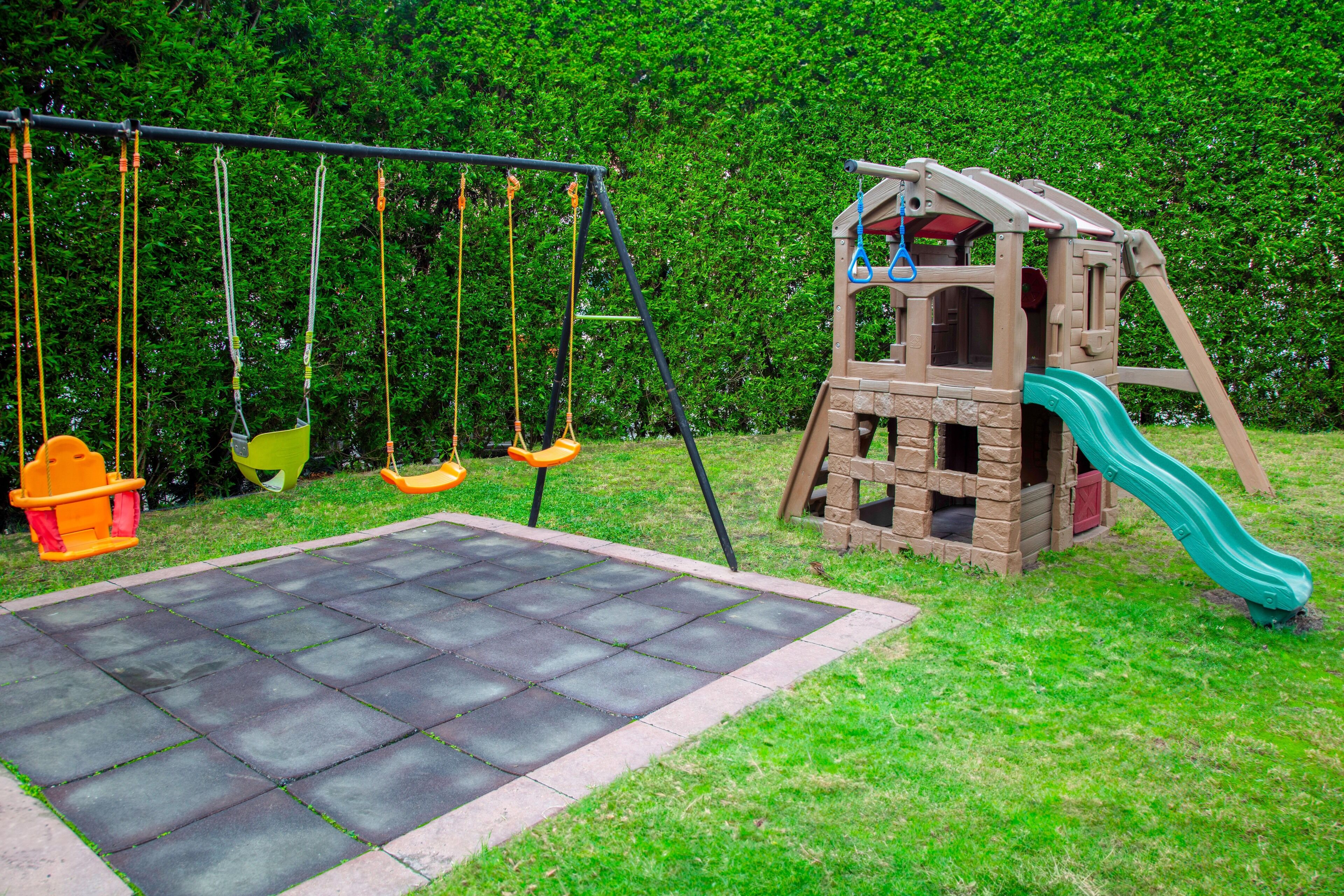 A playground with swings and a slide.