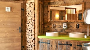 A wooden bathroom with a WC sign, a mirror, two sinks, and a toilet. - Le Clos du Hahnenberg (Urmatt)