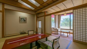 A traditional Japanese room with tatami flooring, a low wooden table, and shoji screens.