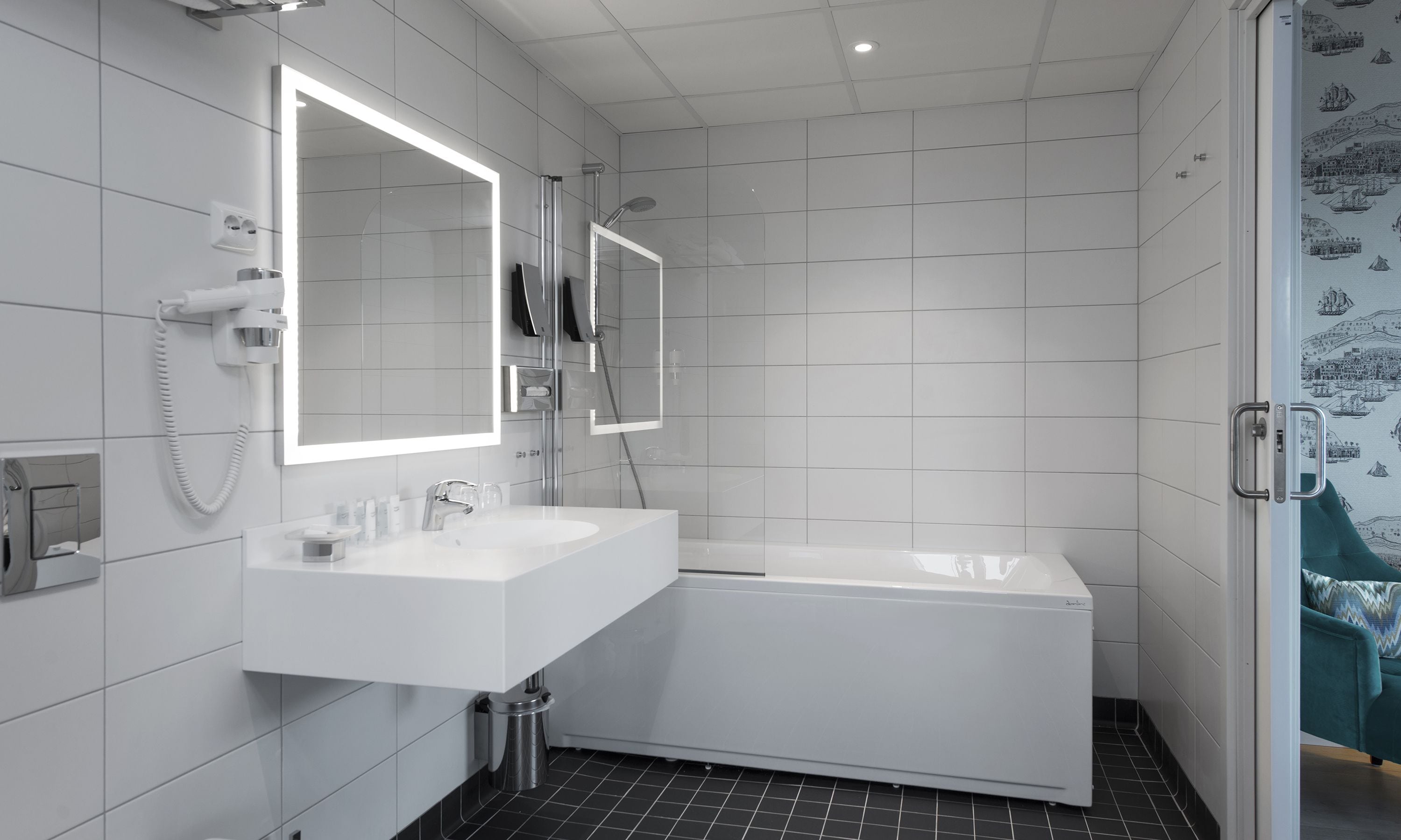 A modern bathroom with a white vanity, a bathtub, and a shower.