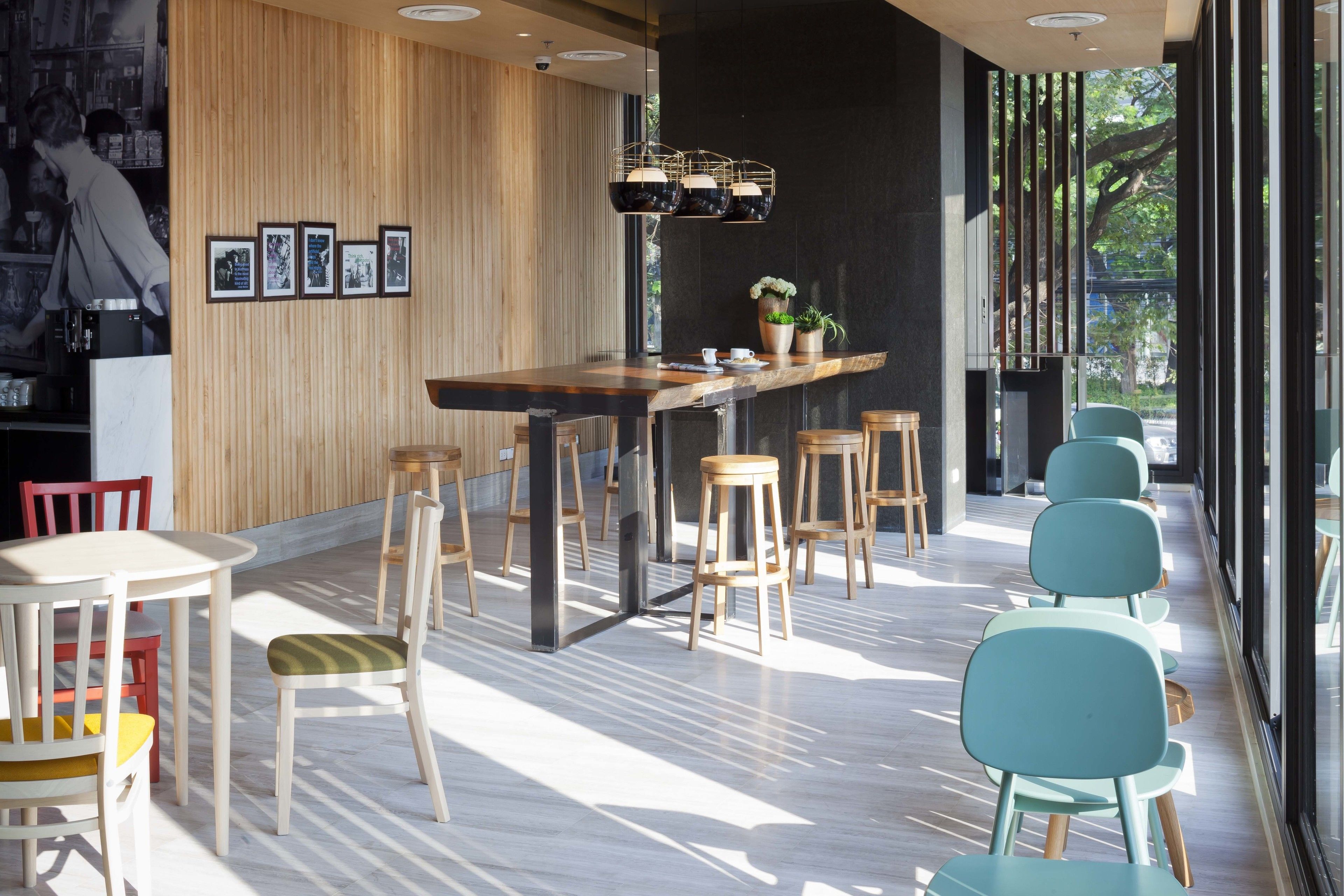 A modern interior with a wooden bar area, seating, and framed pictures on the wall.