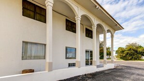 A building with a white facade, multiple windows, and a covered porch area. - Motel 6 Waco, TX - Lacy Lakeview (Waco)