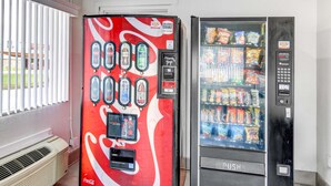 Two vending machines, one with a Coca-Cola logo and another with a 'Thank You!' sign, in a room with a window and a vent. - Motel 6 Waco, TX - Lacy Lakeview (Waco)