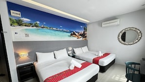 A hotel room with two beds, a mural of a beach scene, a mirror, and a desk with a chair.