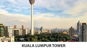 The Kuala Lumpur Tower with surrounding cityscape and greenery.