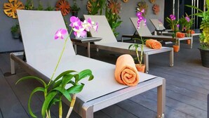 A spa area with sun loungers, potted plants, and decorative wall art. - Citrus Sukhumvit 11 Bangkok by Compass Hospitality (Bangkok)