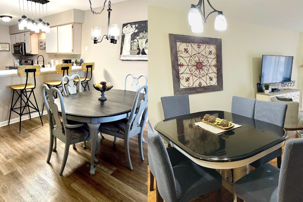 A dining area with a round table and chairs, a kitchen with cabinets and appliances, and a living area with a TV and artwork.