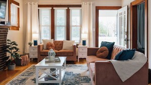 Una sala de estar con sofá, mesa de centro y chimenea.