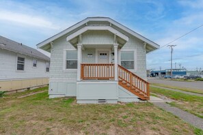 Situated on a grassy area, this single-story home features a gabled roof and a front porch.