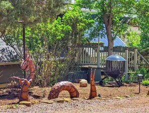 Stroll through a serene outdoor space surrounded by sculptures and lush greenery.