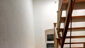 A staircase with wooden steps and a wooden handrail. - Studio apartment in Ika with Balcony, Air condition, WIFI, Washing machine (5025-3) (Ika)