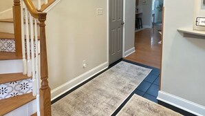 A staircase with wooden railings and a door leading to another room. - Country Home near Chattanooga, Harrison Bay, Howe Farms, and Gray Dove venues! (Ooltewah)