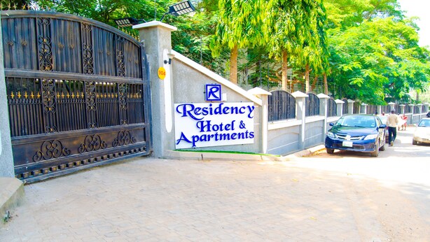 A gated entrance to a property with a sign reading "Residency Hotel & Apartments." - Residency Hotel & Apartments (Abuja)
