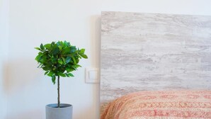 A room with a bed, a grey potted plant, and a patterned bedspread. - 2 bedroom apartment with large terrace (Málaga)