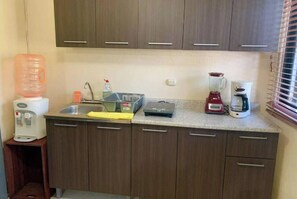 Enjoy cooking and preparing meals in this well-equipped kitchen with a water dispenser, coffee maker, and blender.