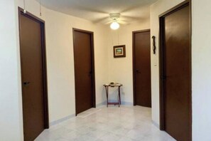 Stylish hallway with individual rooms, a central table, and a framed picture.