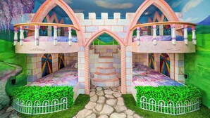 A castle-themed playroom with two bunk beds, a central archway, and a stone pathway. - Luxe 8BR Villa by Disney | Arcade and Private Pool (Kissimmee)