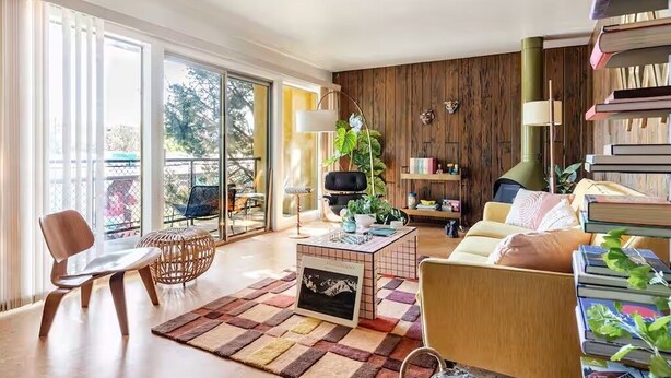 A modern living room with a sofa, a coffee table, and a bookshelf. - Downtown Mid-Century Modern Condo with Retro Vibes (Boise)