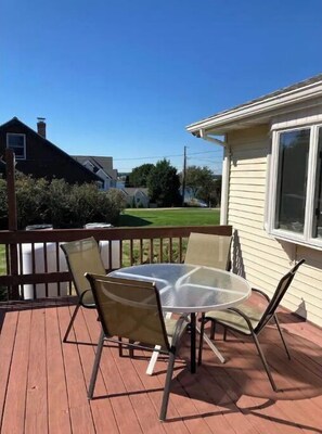 Relax on the deck with a round table and four chairs.