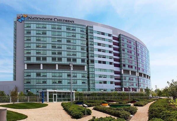A modern building with a curved facade, large windows, and a sign reading "Nationwide Children's".