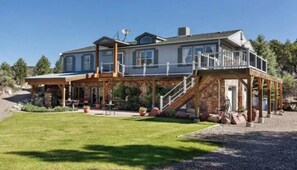 Stunning two-story residence with a spacious balcony overlooking a beautifully manicured lawn.