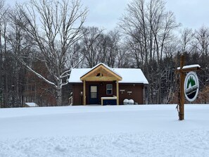Escape to a serene winter retreat surrounded by snow-covered trees and a tranquil atmosphere.