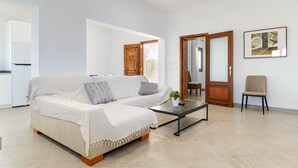 A modern living room with a sofa, coffee table, and a chair. - YourHouse Goet, villa with private pool (Sa Pobla)