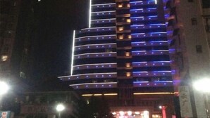 A multi-story hotel with illuminated balconies and a prominent entrance. - Ru Jiang Hotel (Zhong County)