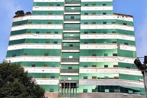 A multi-story building with a central staircase, large windows, and a flat facade. - Ru Jiang Hotel (Zhong County)