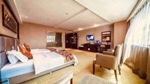 A hotel room with a bed, a desk, a chair, a television, and a large window. - Ru Jiang Hotel (Zhong County)