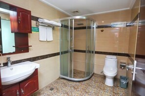 A bathroom with a glass-enclosed shower, a white sink, and a toilet. - Ru Jiang Hotel (Zhong County)